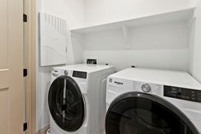 Phoenix apartment for rent - Two white Whirlpool washing machines in a laundry room.