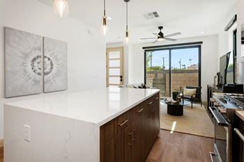 Epicurean kitchen with quartz waterfall countertops