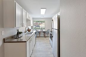 Gresham apartment for rent - A kitchen with white cabinets and a wooden floor.