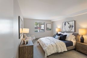 Gresham apartment for rent - A bedroom with a large bed and a window.