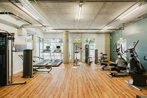 Portland apartment for rent - Community gym/fitness center with machines and weights at 2121 Belmont apartments in the Buckman neighborhood in Portland, Oregon.