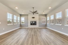 Gunter apartment for rent - A spacious room with a fireplace and wood flooring.at Four Cedars, Gunter