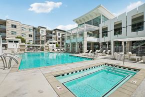 Bluffdale apartment for rent - A swimming pool in front of apartment buildings.