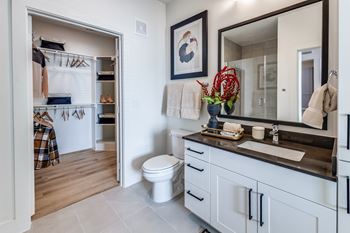 Spacious walk-in closets with custom wood shelving