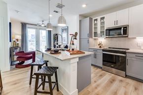 Austin apartment for rent - A modern kitchen with a bar stool and a countertop.