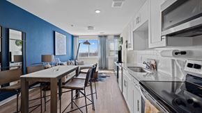 Denver apartment for rent - a kitchen and living room with blue walls and white cabinets at Alton Jefferson Park, Denver, 80211
