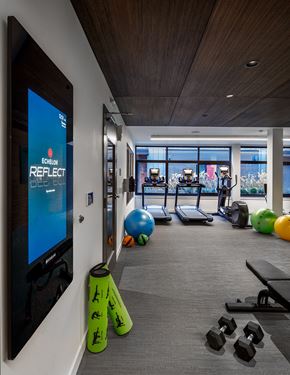 Kirkland apartment for rent - A gym with a screen on the wall that says Echelon Reflect.