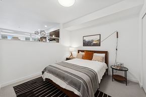Portland apartment for rent - A bedroom with a bed, nightstand, and a picture on the wall.