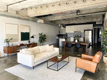 North Hollywood apartment for rent - A living room with a white couch and a brown leather chair.