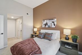 Chula Vista apartment for rent - A bedroom with a bed, nightstand, and lamp.