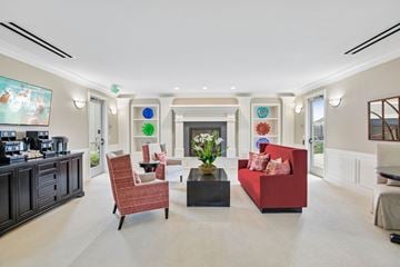 West Jordan townhouse for rent - A living room with a red couch, a black coffee table, and a painting on the wall.