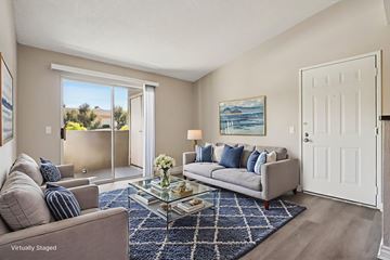 Murrieta apartment for rent - A living room with a grey couch and a painting on the wall.