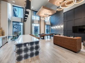 Dallas apartment for rent - A modern kitchen with a checkered table and a wooden bench.