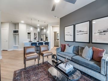 Dallas apartment for rent - A living room with a grey couch and a coffee table.