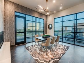 Dallas apartment for rent - A dining room with a table set for four and a view of the city.