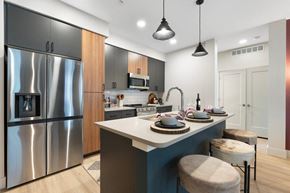 Flagstaff apartment for rent - a kitchen with a island and a stainless steel refrigerator
