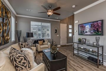 Denver apartment for rent - A living room with a white couch and a black coffee table.