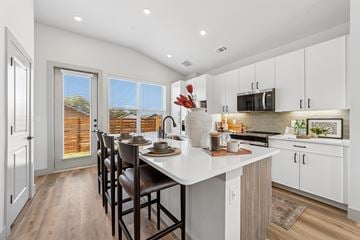 Melissa apartment for rent - A kitchen with a table and chairs in front of a window.