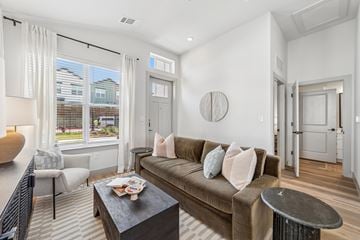 Melissa apartment for rent - A living room with a brown couch and a coffee table.