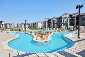 Manor apartment for rent - A swimming pool in front of a row of houses.