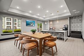 Kyle apartment for rent - A modern dining room with a wooden table and chairs.