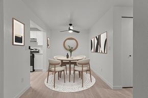 Bothell apartment for rent - a dining room with a round table and chairs and a ceiling fan