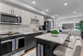Seattle apartment for rent - A modern kitchen with a black oven and a white countertop.