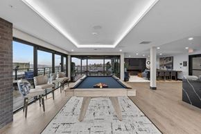 Seattle apartment for rent - A billiard table is in the middle of a room with a brick wall and a pool table.