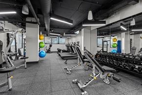 Seattle apartment for rent - A gym with a variety of equipment including treadmills, weights, and exercise balls.