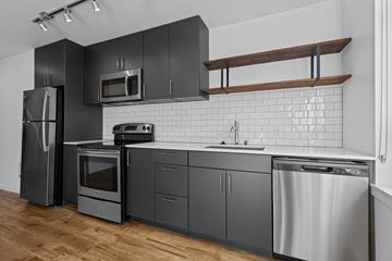 Seattle apartment for rent - a kitchen with stainless steel appliances and black cabinets