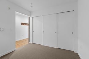 Seattle apartment for rent - a bedroom with white walls and white closet doors