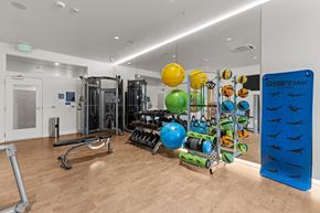 Seattle apartment for rent - a gym with weights and other exercise equipment on a wooden floor
