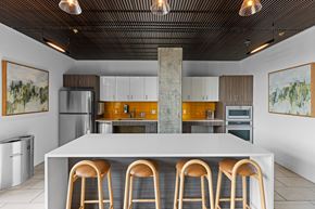 Seattle apartment for rent - a kitchen with a white counter top and four stools