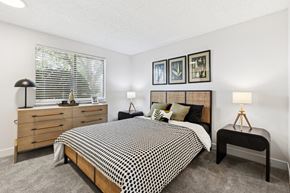 Renton apartment for rent - A bedroom with a bed, nightstands, and pictures on the wall.
