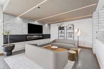 Pasco apartment for rent - A modern living room with a grey sofa and a stone fireplace.