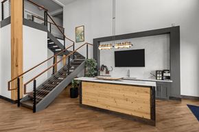 Colorado Springs apartment for rent - A modern kitchen with a wooden counter and a staircase.