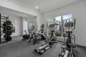 Colorado Springs apartment for rent - A well-equipped gym with various exercise machines and weights.