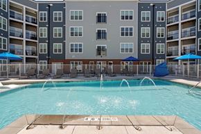 Colorado Springs apartment for rent - A large swimming pool in front of apartment buildings with a 4'6