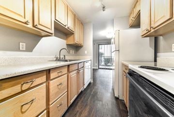 Seattle apartment for rent - a kitchen with wooden cabinets and a stove and a refrigerator