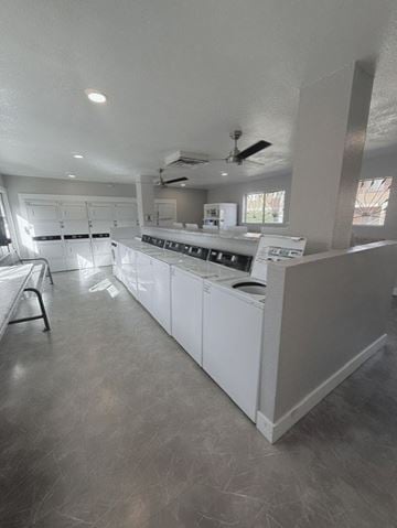 Tucson apartment for rent - A kitchen with white cabinets and a ceiling fan.