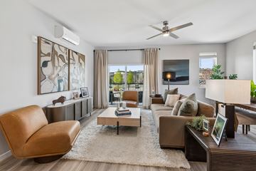 Durango apartment for rent - A living room with a brown leather chair and a coffee table.