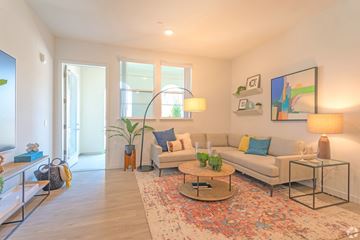 Livermore apartment for rent - A living room with a couch, coffee table, and a painting on the wall.