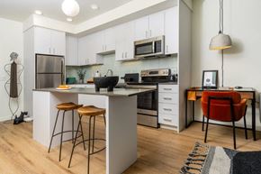 Kent apartment for rent - a kitchen with an island and a stove and a microwave