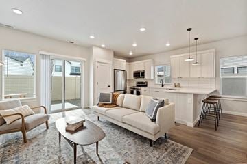 Garden City apartment for rent - A modern living room with a white sofa and a coffee table.