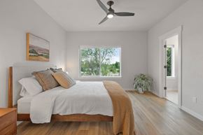 Garden City apartment for rent - A bedroom with a large bed and a painting on the wall.