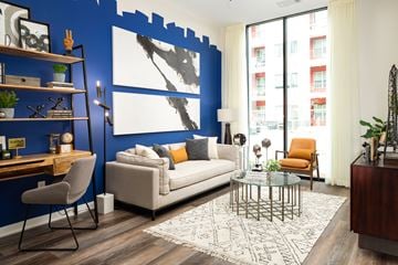Atlanta apartment for rent - a living room with a blue accent wall and a white couch