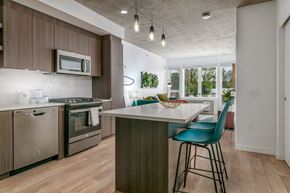 Portland apartment for rent - A kitchen with a white counter top and a blue chair.