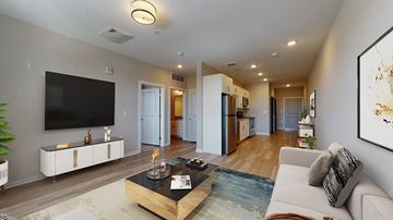 Denver apartment for rent - A living room with a white couch and a black coffee table.