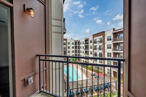 Charlotte apartment for rent - A balcony with a pool and a building in the background.