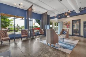 Charlotte apartment for rent - A spacious waiting area with blue walls and brown chairs.